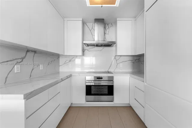 a kitchen with kitchen island a sink stainless steel appliances and cabinets