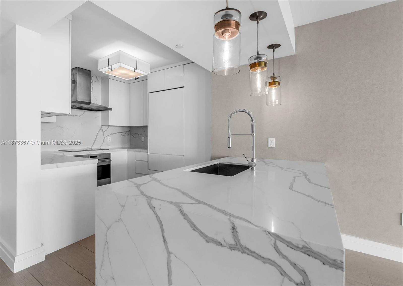 10 Venetian Way, Unit 1903 Miami Beach, FL 33139 - Photo 12 of 49 a kitchen with kitchen island a sink stainless steel appliances and cabinets