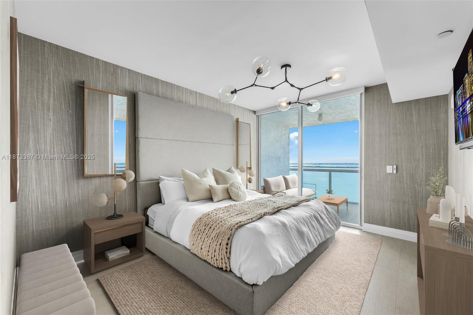 10 Venetian Way, Unit 1903 Miami Beach, FL 33139 - Photo 17 of 49 a bedroom with double bed and a chandelier