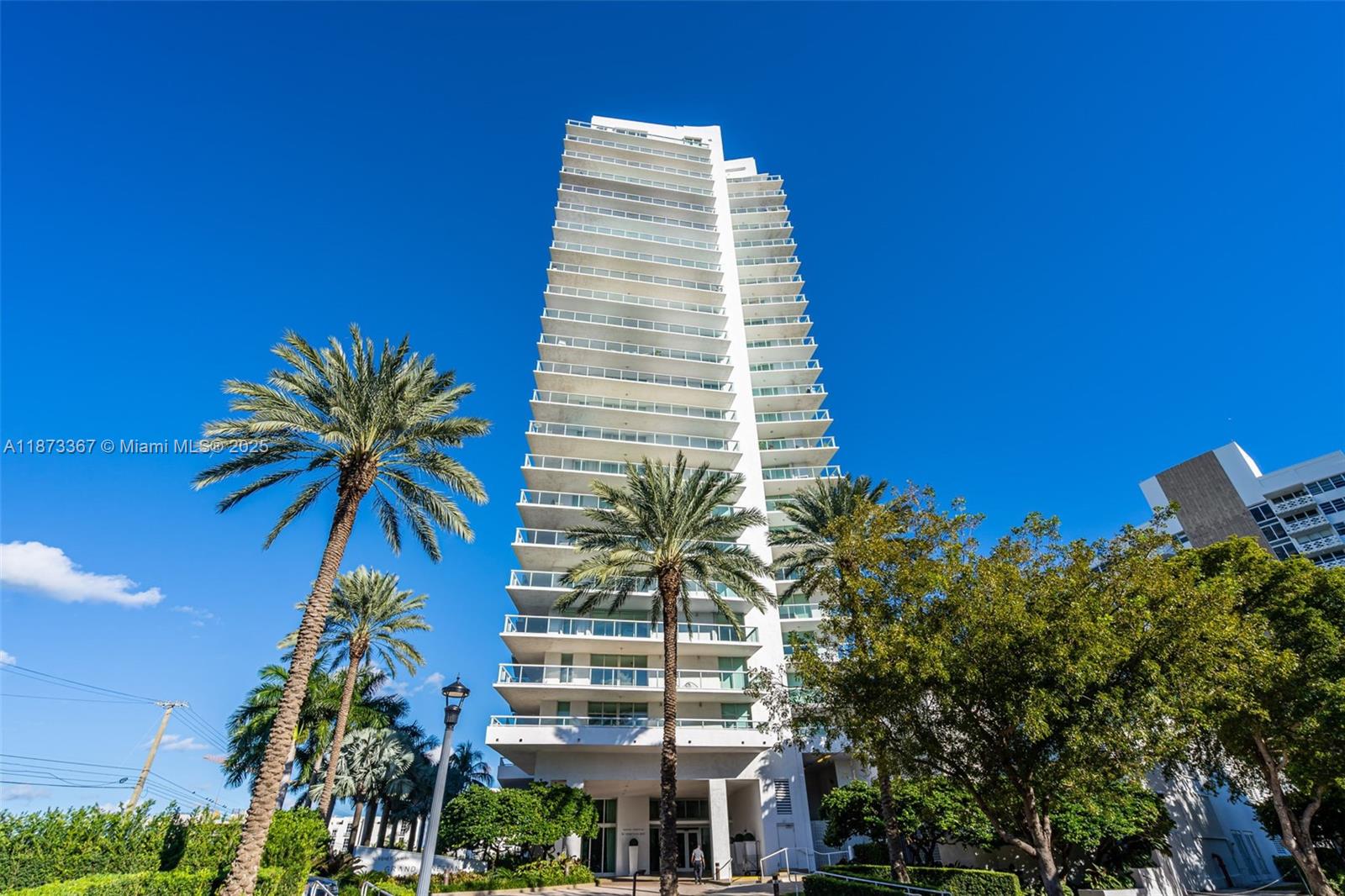 10 Venetian Way, Unit 1903 Miami Beach, FL 33139 - Photo 49 of 49 a tall building with a trees in front of it