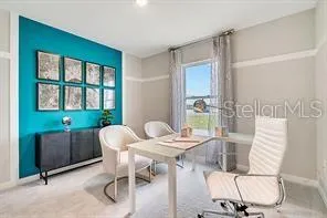 a living room with furniture and a large window with potted plants