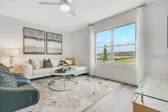 a dining room with furniture a window and wooden floor