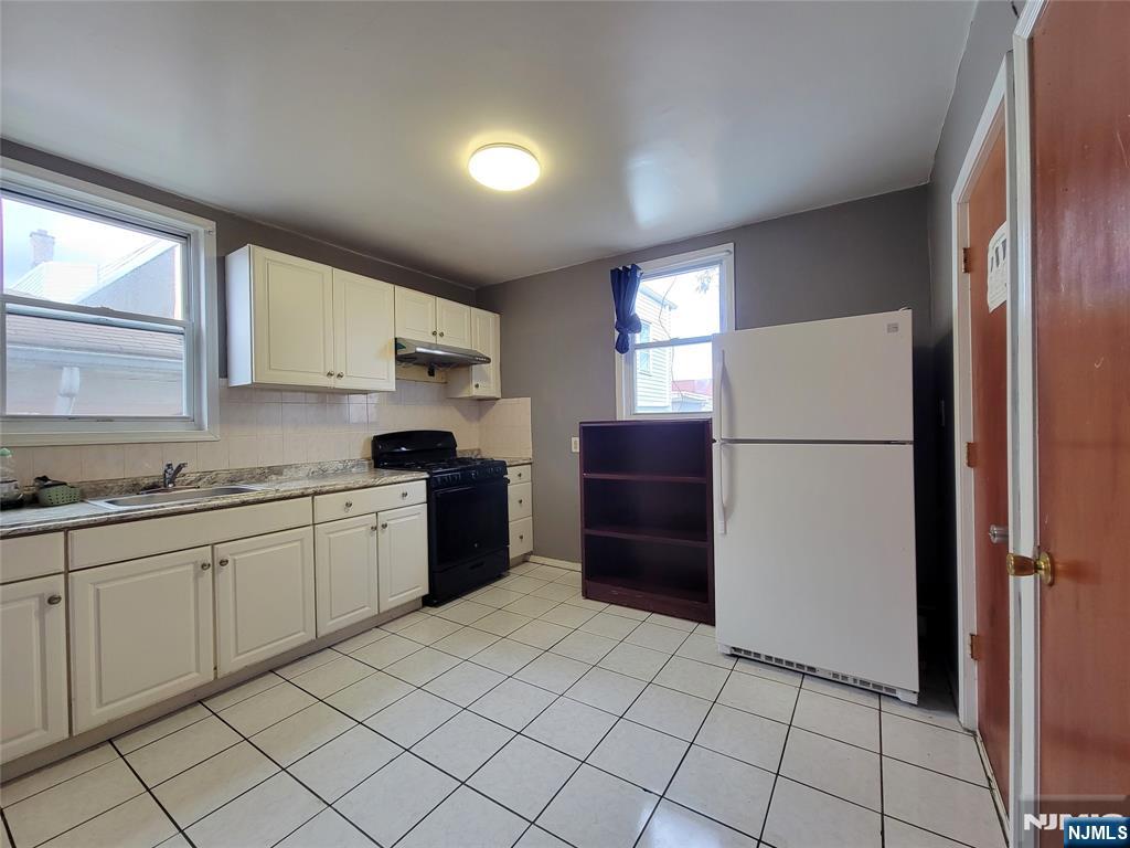 6 6th Street Harrison, NJ 07029 - Photo 4 of 12 a kitchen with a refrigerator and a sink