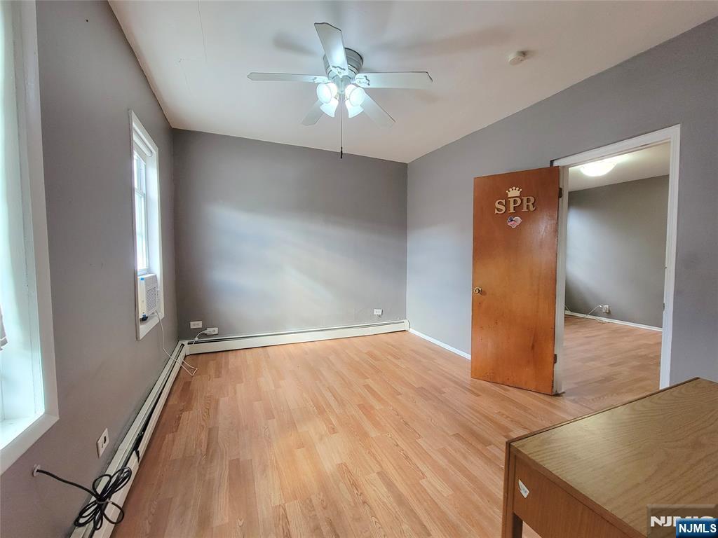 6 6th Street Harrison, NJ 07029 - Photo 6 of 12 wooden floor in an empty room with a window