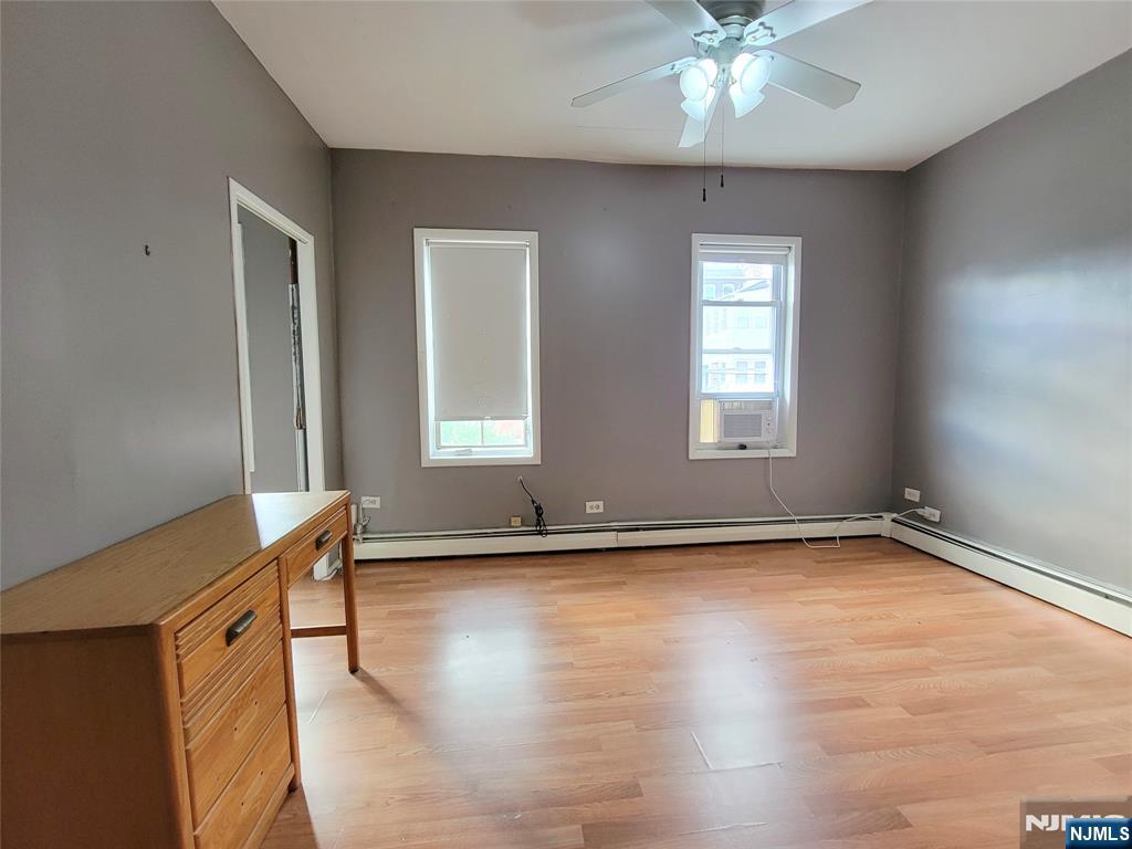 6 6th Street Harrison, NJ 07029 - Photo 7 of 12 a view of an empty room with window and wooden floor