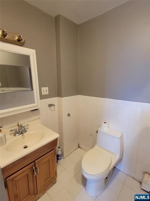 6 6th Street Harrison, NJ 07029 - Photo 10 of 12 a bathroom with a sink toilet and mirror
