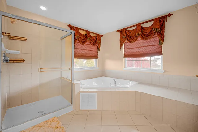 a bathroom with a tub sink and mirror