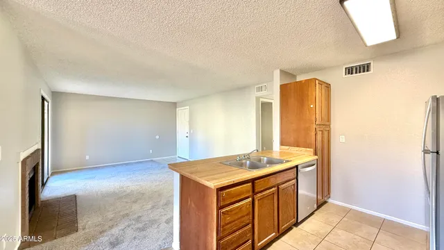 a view of kitchen with granite countertop cabinets and sink
