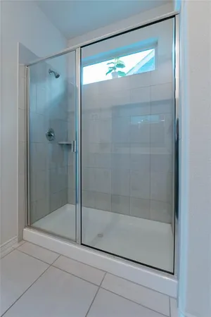a bathroom with a glass shower door