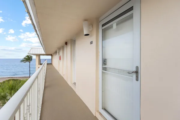 a view of a balcony with wooden floor and fence