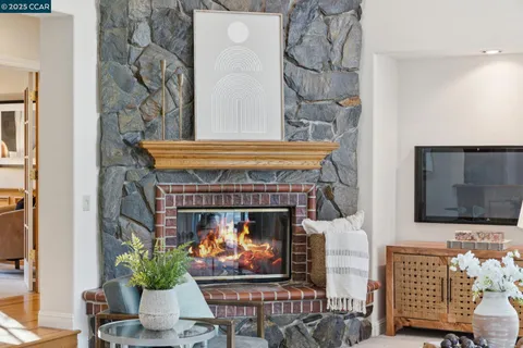 a living room with furniture large window and flat screen tv