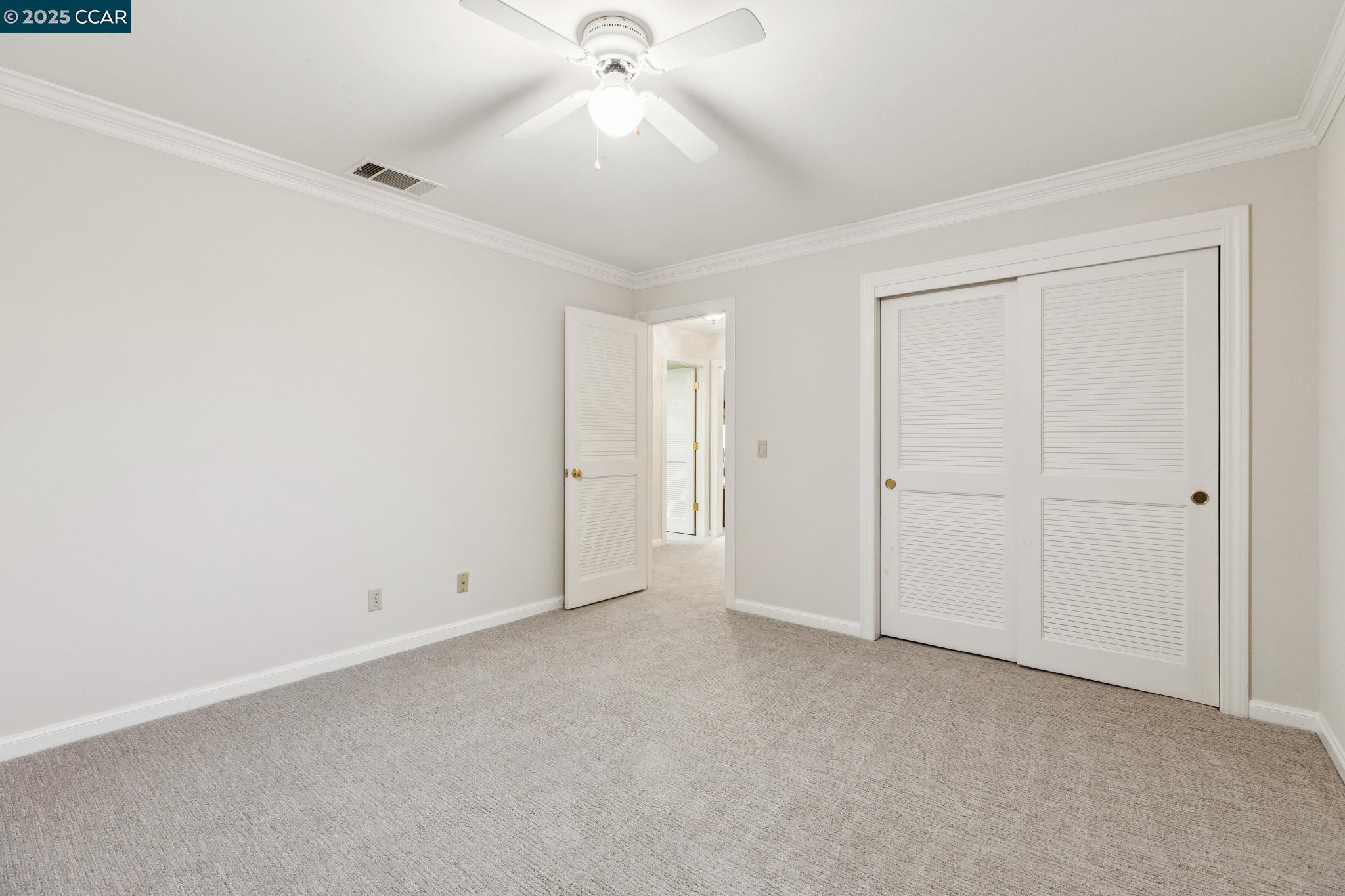 788 Woodwind Place Walnut Creek, CA 94598 - Photo 39 of 48 an empty room with a ceiling fan and closet area