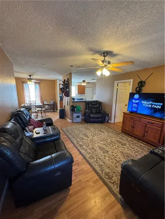 a living room with furniture a fireplace and a chandelier