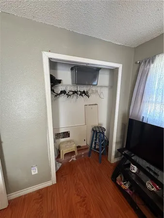 a view of workspace with wooden floor flat screen tv and windows