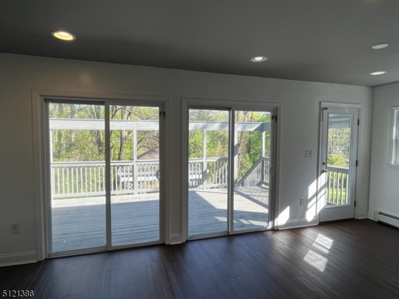 636 Valley Road Watchung, NJ 07069 - Photo 12 of 43 a view of an empty room with wooden floor and a window