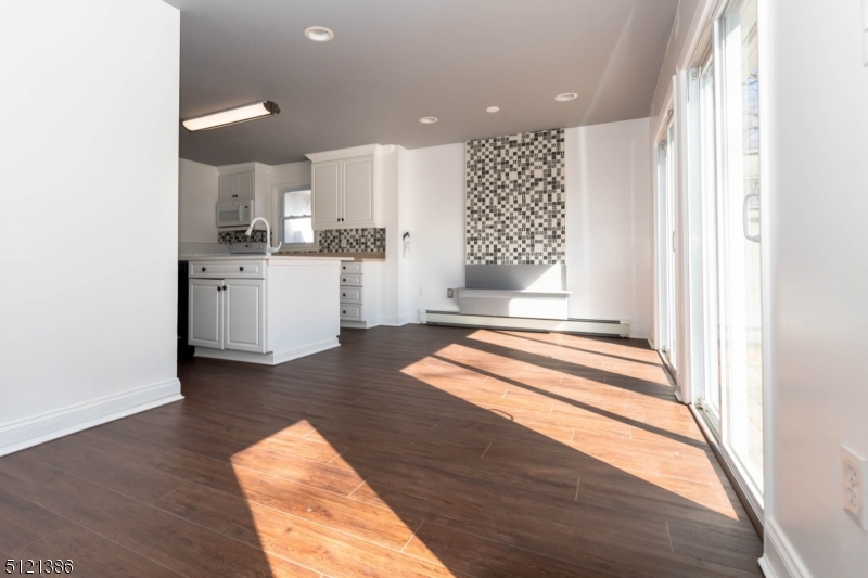 636 Valley Road Watchung, NJ 07069 - Photo 14 of 43 a open kitchen with white cabinets and wooden floor