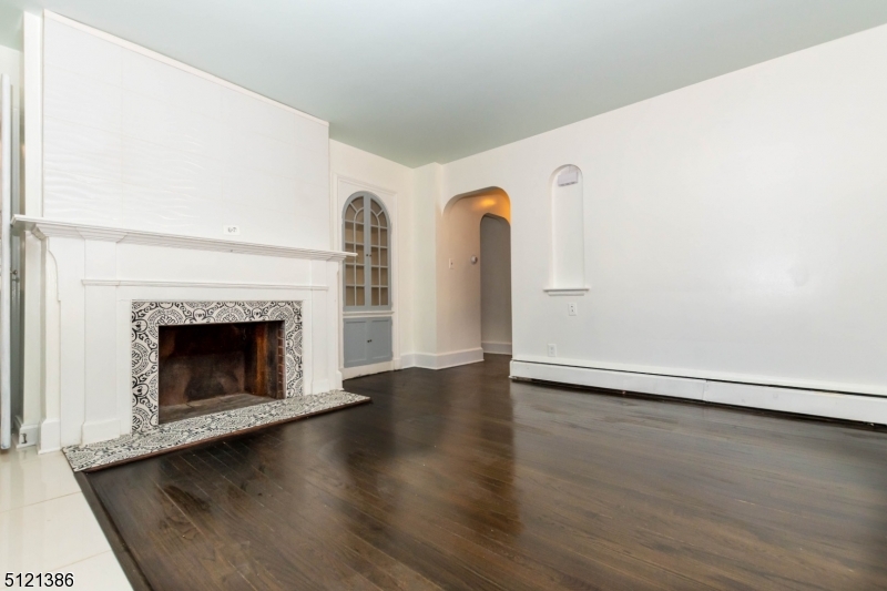 636 Valley Road Watchung, NJ 07069 - Photo 18 of 43 a view of an empty room with wooden floor and a fireplace