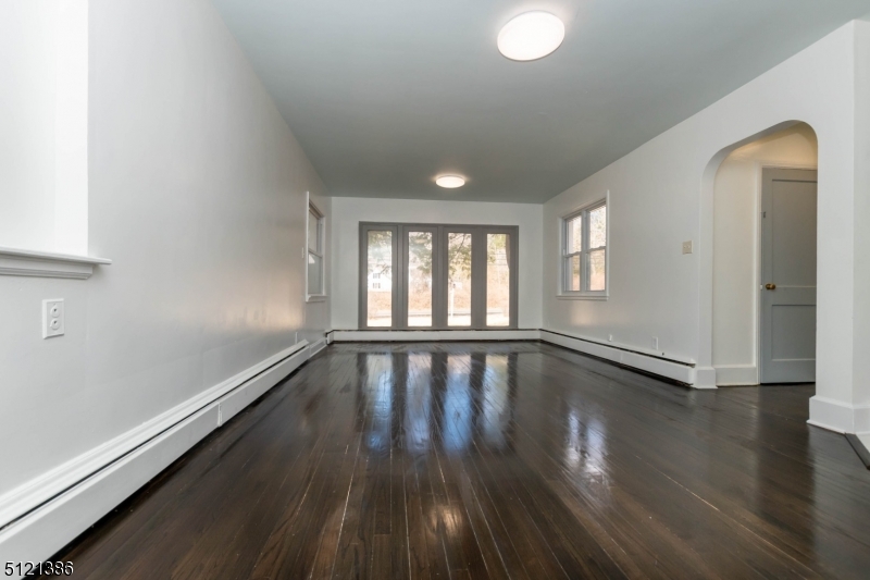 636 Valley Road Watchung, NJ 07069 - Photo 20 of 43 a view of an empty room with wooden floor and a window