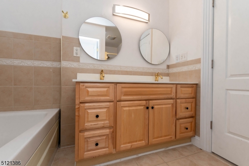 636 Valley Road Watchung, NJ 07069 - Photo 23 of 43 a bathroom with a sink a vanity and a mirror