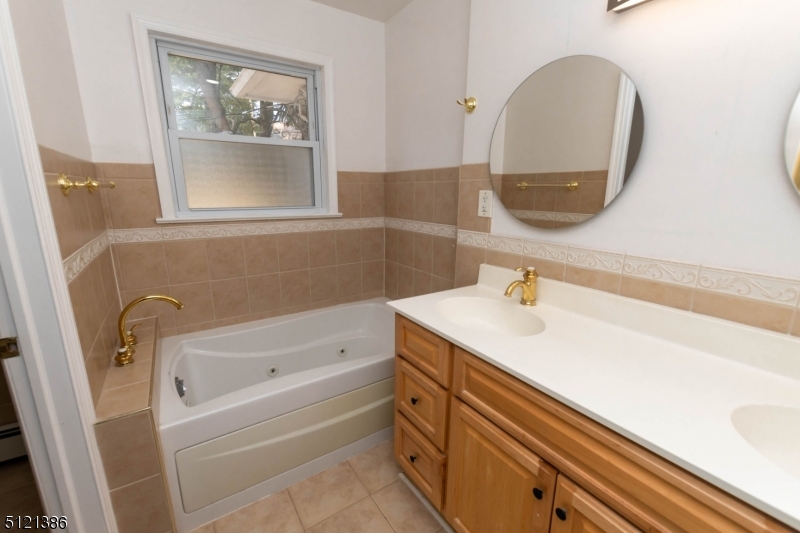 636 Valley Road Watchung, NJ 07069 - Photo 24 of 43 a bathroom with a sink and a mirror