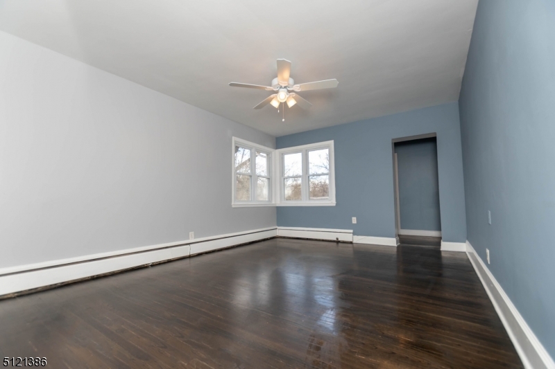 636 Valley Road Watchung, NJ 07069 - Photo 26 of 43 an empty room with wooden floor ceiling fan and windows