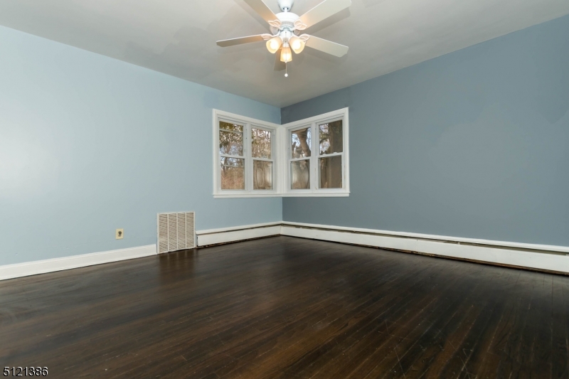 636 Valley Road Watchung, NJ 07069 - Photo 28 of 43 a view of an empty room with window and wooden floor