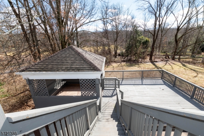 636 Valley Road Watchung, NJ 07069 - Photo 35 of 43 a view of a balcony with two chairs and a barbeque