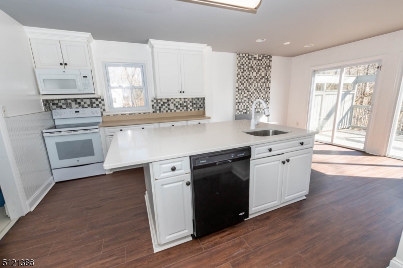 636 Valley Road Watchung, NJ 07069 - Photo 7 of 43 a kitchen with granite countertop white cabinets and white appliances
