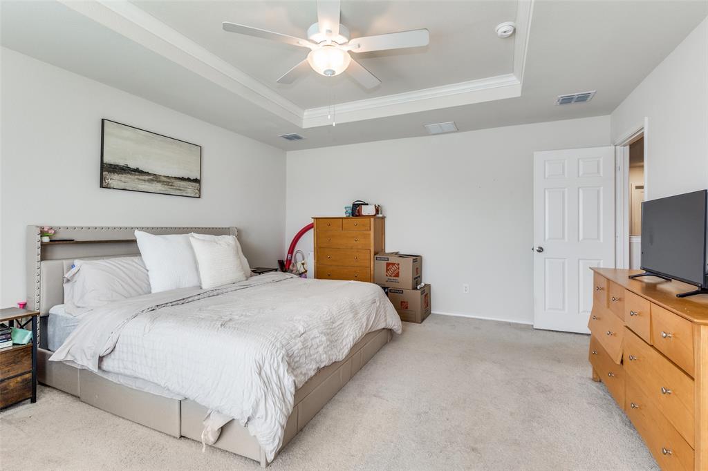 16024 Pemberly Lane Haslet, TX 76052 - Photo 17 of 23 a bedroom with a bed and a flat screen tv