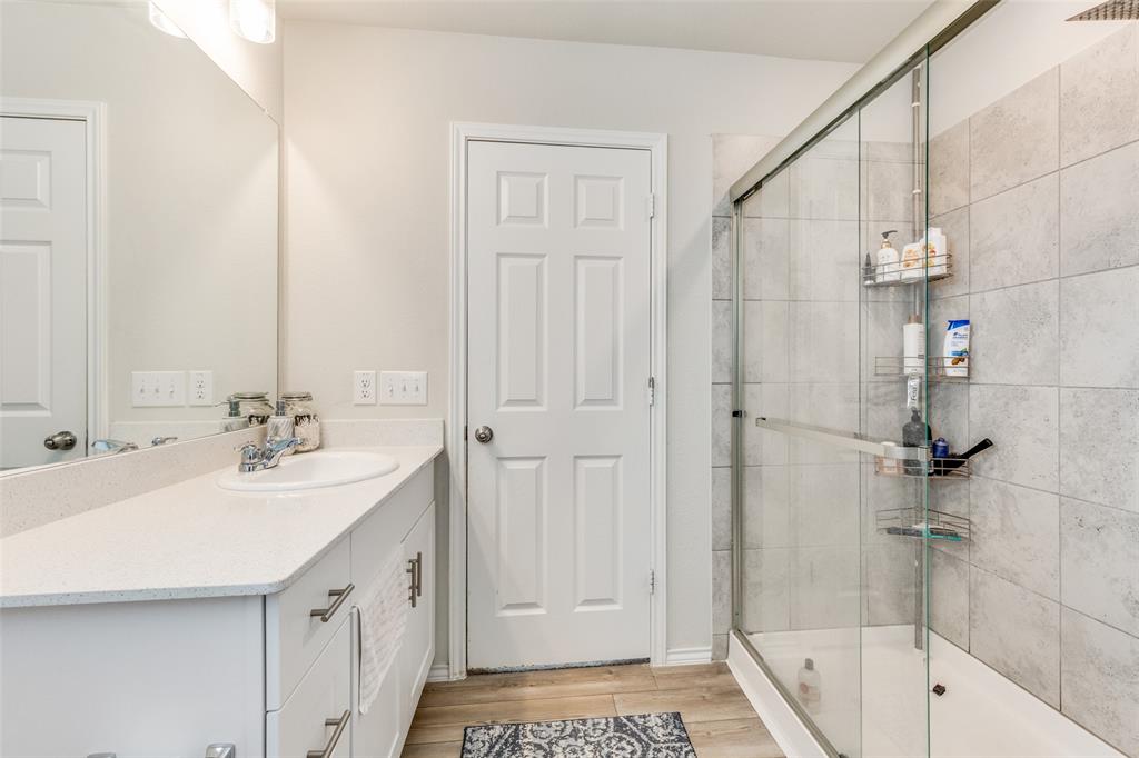 16024 Pemberly Lane Haslet, TX 76052 - Photo 18 of 23 a bathroom with a sink a mirror and a bathtub