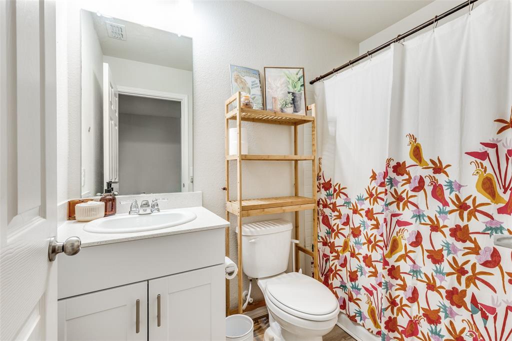 16024 Pemberly Lane Haslet, TX 76052 - Photo 22 of 23 a bathroom with a sink a toilet and shower curtain