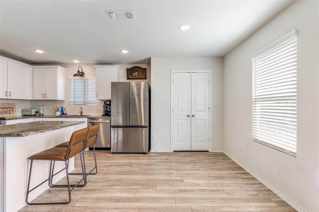 16024 Pemberly Lane Haslet, TX 76052 - Photo 9 of 23 a kitchen with a refrigerator a sink and a stove top oven