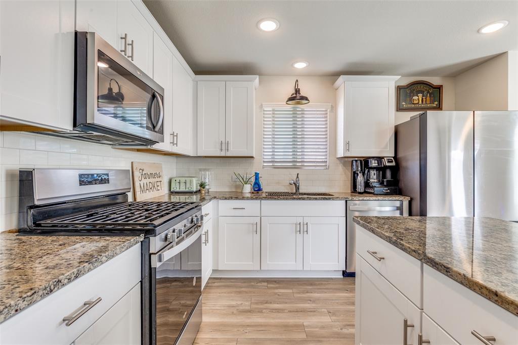 16024 Pemberly Lane Haslet, TX 76052 - Photo 10 of 23 a kitchen with stainless steel appliances granite countertop a stove a sink and a refrigerator