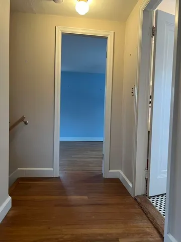 a view of a room with wooden floor and windows