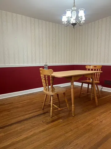 a view of a livingroom with wooden floor and stairs