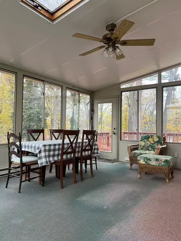 a living room with furniture and floor to ceiling windows