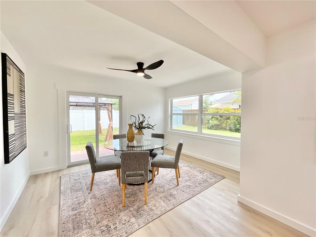 1290 Michigan Boulevard Dunedin, FL 34698 - Photo 13 of 45 a dining room with wooden floor and a window