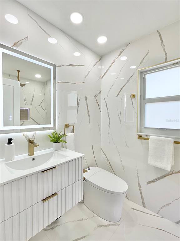 1290 Michigan Boulevard Dunedin, FL 34698 - Photo 18 of 45 a bathroom with a sink toilet and shower
