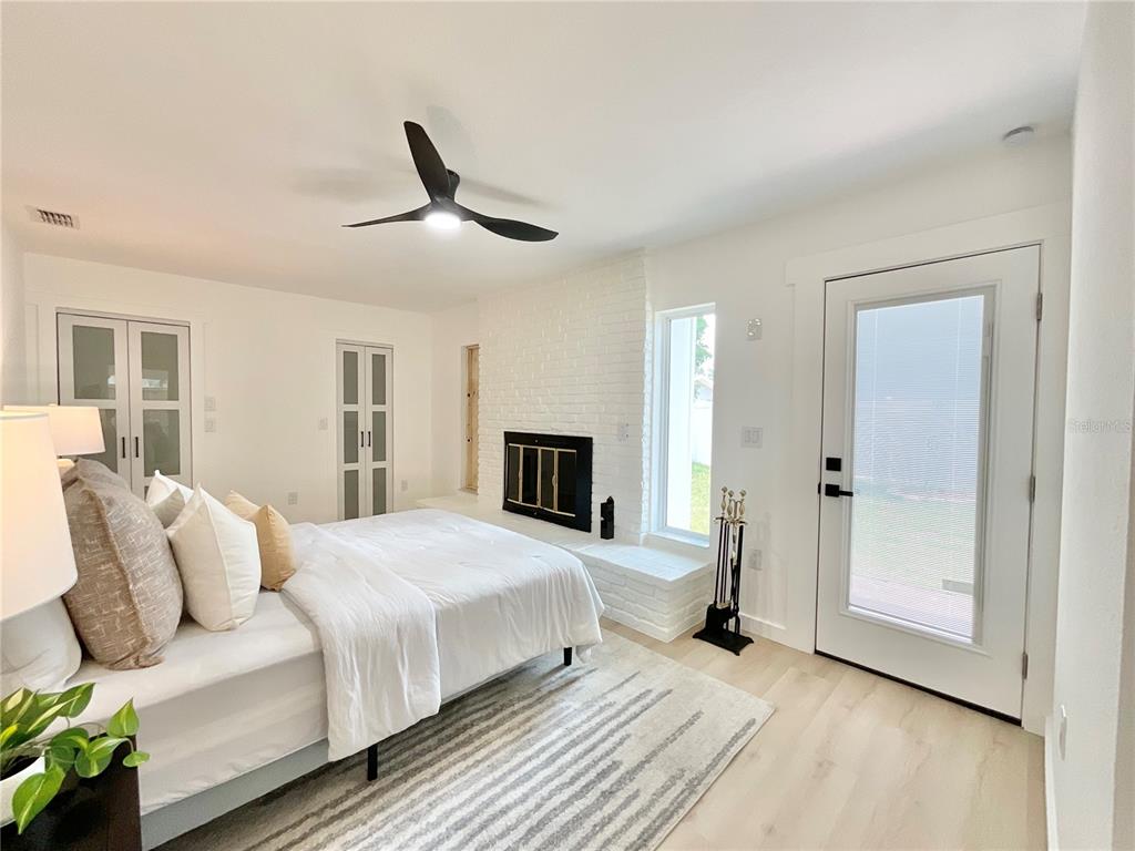 1290 Michigan Boulevard Dunedin, FL 34698 - Photo 21 of 45 a bedroom with a bed and a chandelier