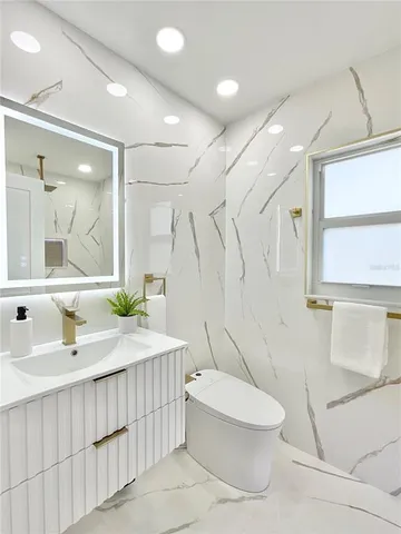 a bathroom with a sink toilet and shower