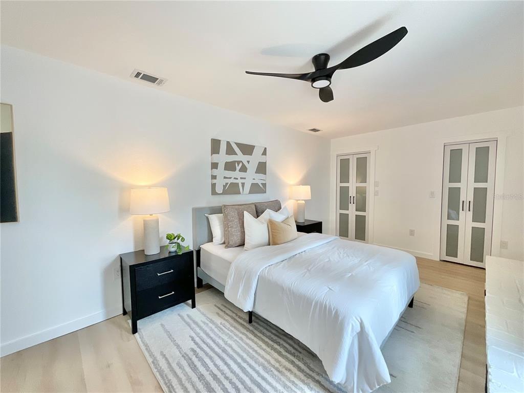 1290 Michigan Boulevard Dunedin, FL 34698 - Photo 23 of 45 a bedroom with a bed and a ceiling fan