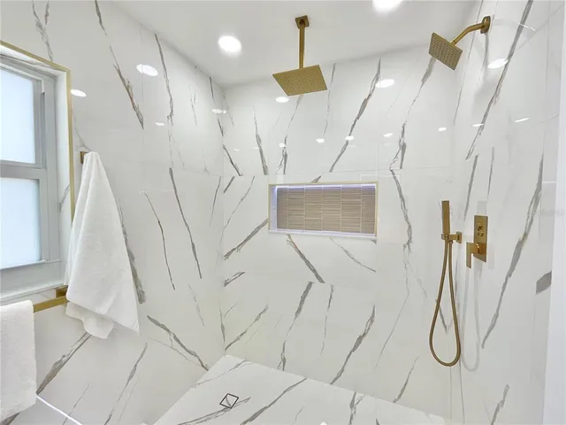 a bathroom with a bathtub and a shower