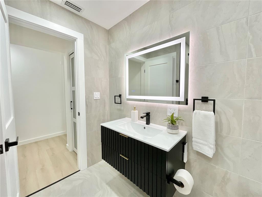1290 Michigan Boulevard Dunedin, FL 34698 - Photo 28 of 45 a bathroom with a sink and a mirror