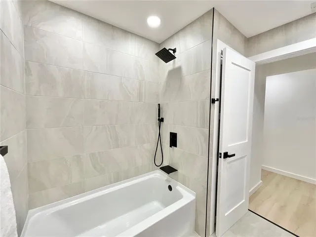 a bathroom with a bathtub and a shower