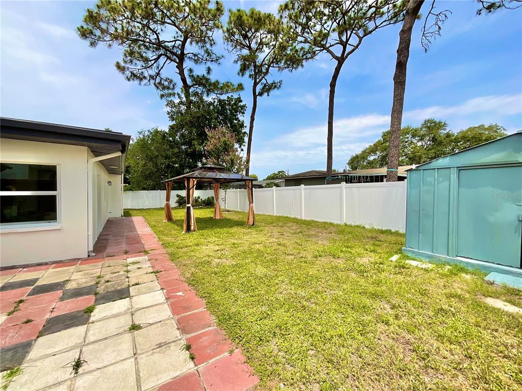 1290 Michigan Boulevard Dunedin, FL 34698 - Photo 36 of 45 a view of swimming pool with a yard