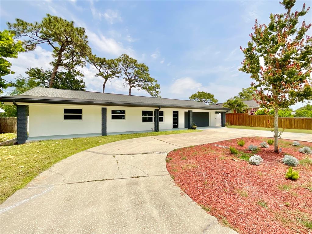 1290 Michigan Boulevard Dunedin, FL 34698 - Photo 41 of 45 front view of a house with a porch