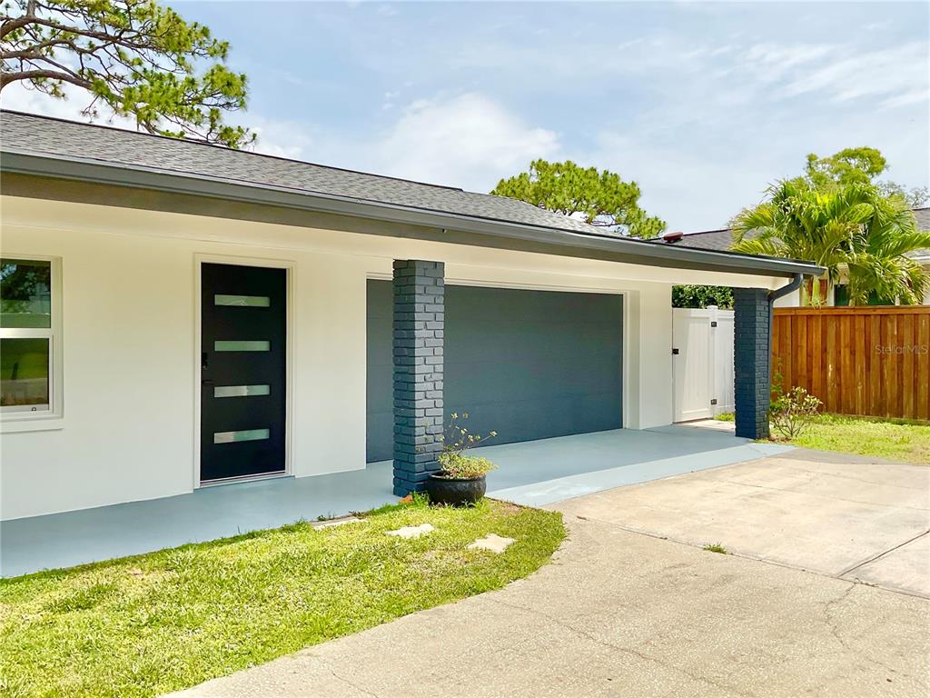 1290 Michigan Boulevard Dunedin, FL 34698 - Photo 42 of 45 a front view of house with garage
