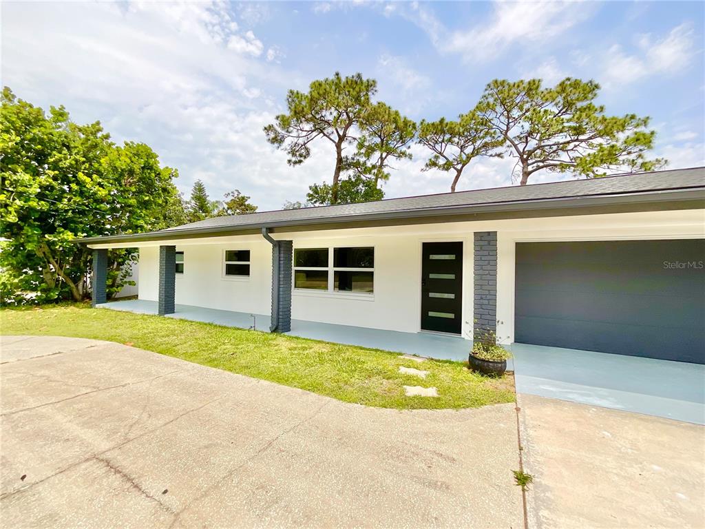 1290 Michigan Boulevard Dunedin, FL 34698 - Photo 45 of 45 front view of a house with a patio