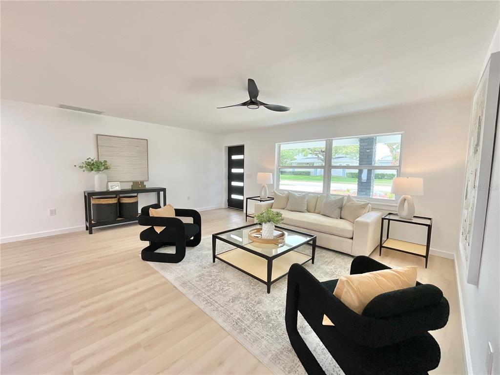 1290 Michigan Boulevard Dunedin, FL 34698 - Photo 9 of 45 a living room with furniture and a window