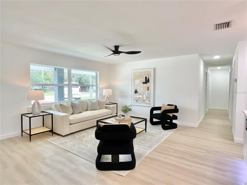 1290 Michigan Boulevard Dunedin, FL 34698 - Photo 10 of 45 a living room with furniture ceiling fan and a window